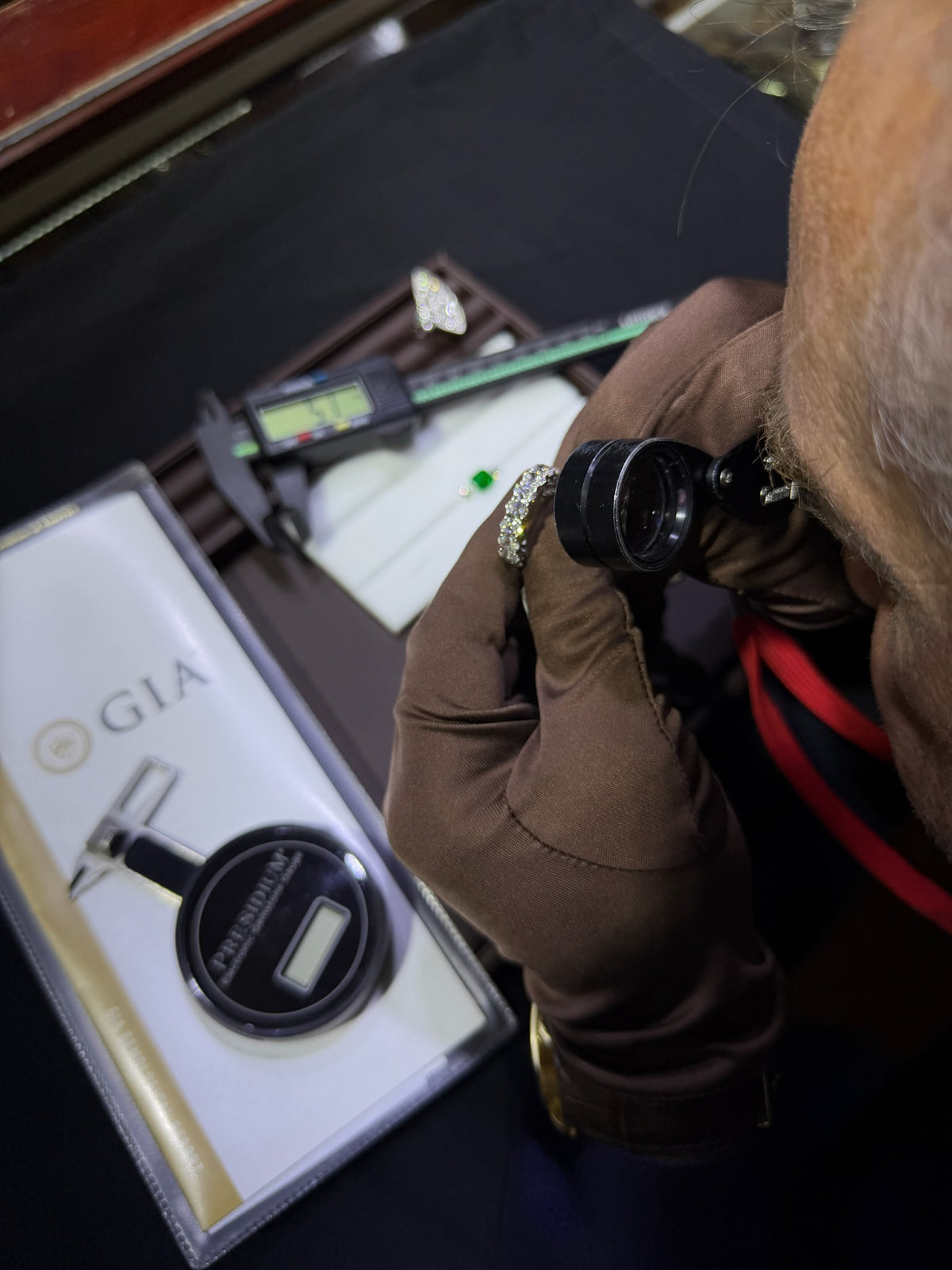Kupfer jeweler inspecting a ring under magnification in the workshop